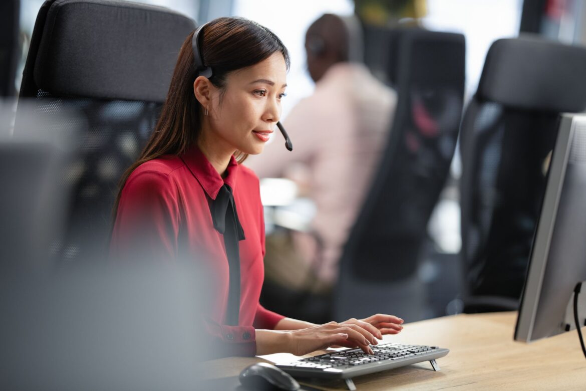 Asian Woman Working In IT Customer Support